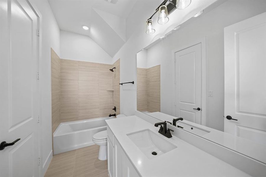 Full bath with shower / bathtub combination, vanity, and vaulted ceiling