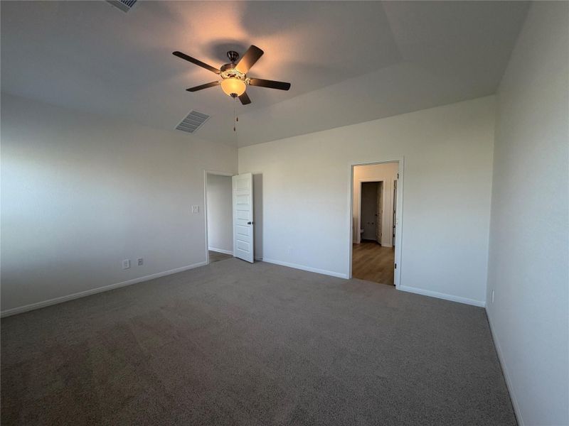 Unfurnished bedroom featuring carpet and ceiling fan