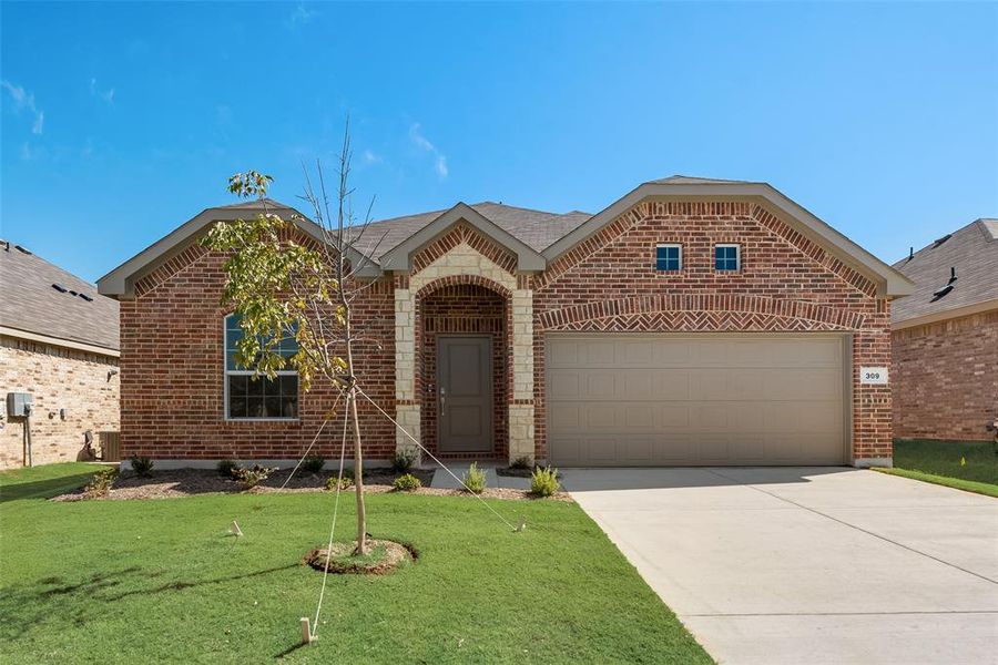 View of front of house featuring a front yard and a garage