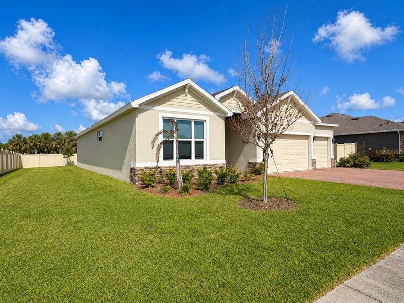 Front exterior of a new home in Crystal Bay Estates, Grant-Valkaria, FL, highlighting curb appeal (Image 21).