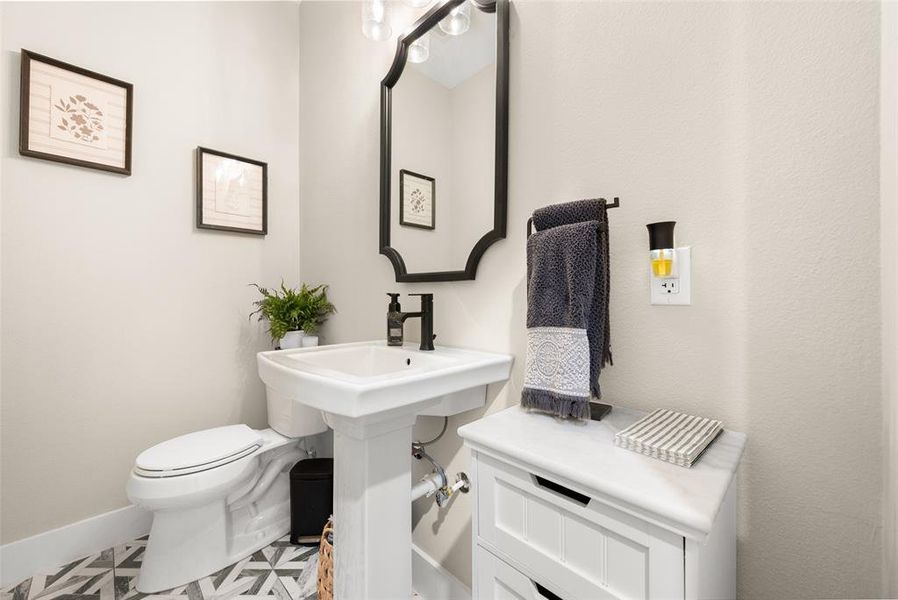 Bathroom featuring tile floors and toilet