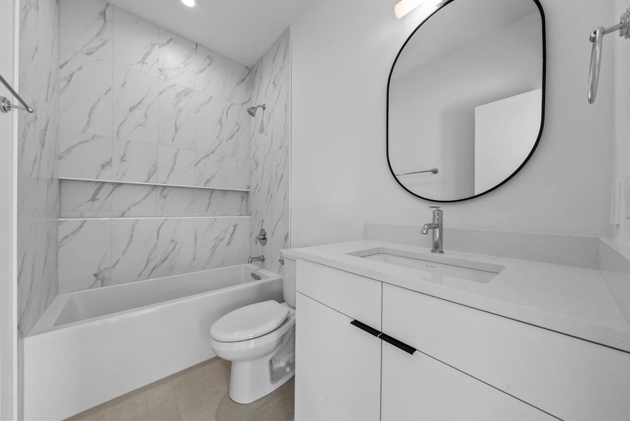 Full secondary bath featuring shower / tub combination and vanity Full secondary bath featuring shower / tub combination and vanity