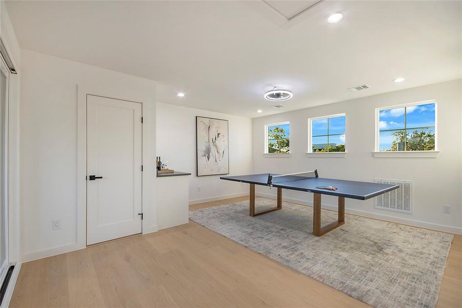 Playroom with recessed lighting and light wood-style floors