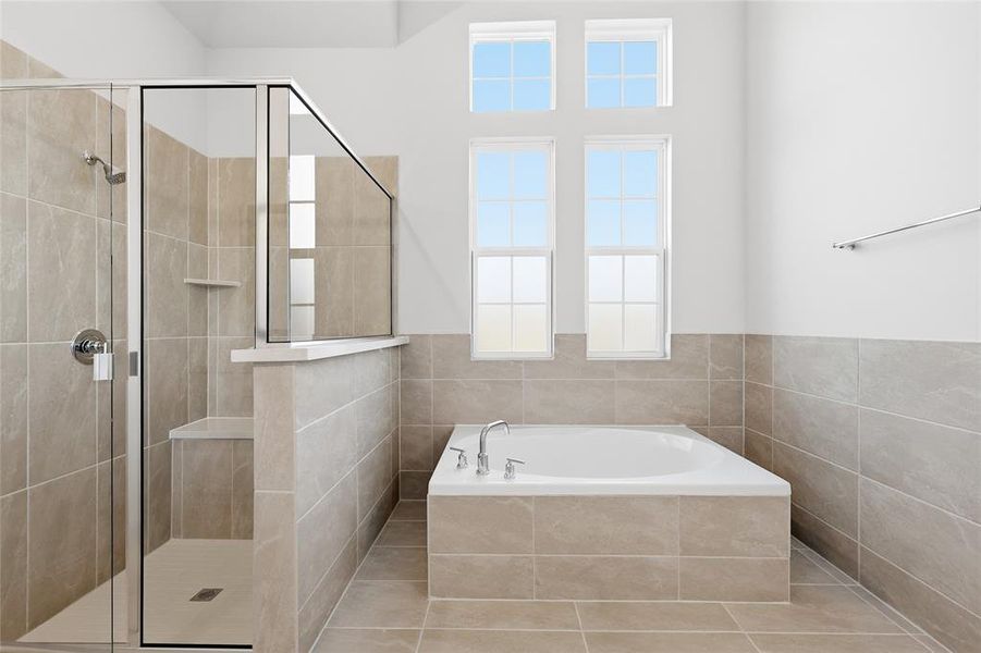 Full bath featuring a garden tub and a stall shower