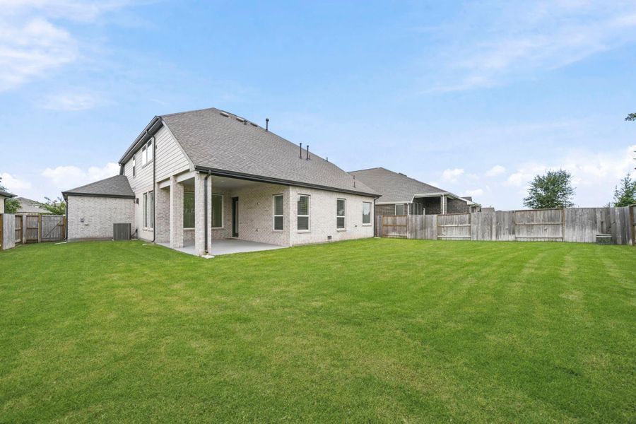 Your covered patio overlooks your huge backyard with plenty of green space to enjoy!