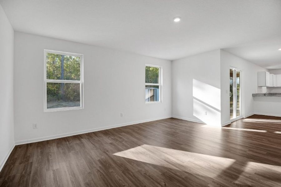 A room with a wood floor and windows. A room with a wood floor and windows.