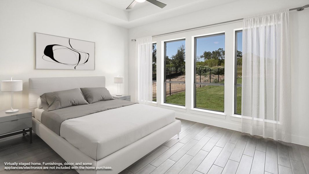Bedroom featuring wood finished floors and ceiling fan Bedroom featuring wood finished floors and ceiling fan