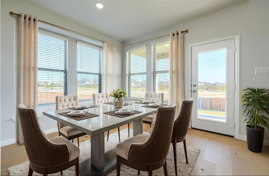 Dining space featuring healthy amount of natural light and light wood-style flooring Dining space featuring healthy amount of natural light and light wood-style flooring