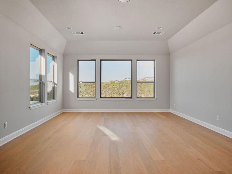 The media room opens to a game room with beautiful Lake Travis views and built-in ceiling speakers.