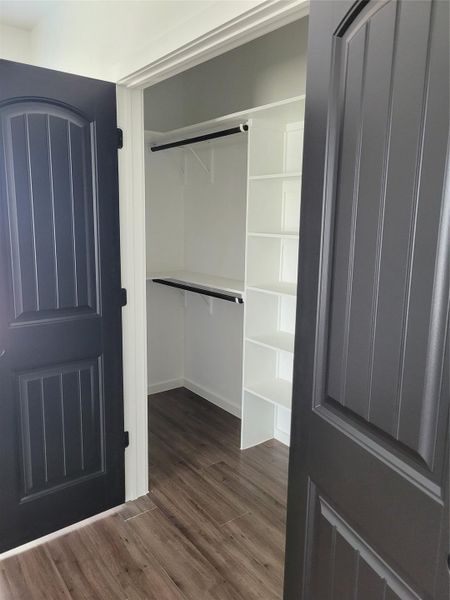 Ample storage solutions await within this well-appointed closet, featuring built-in shelving and hanging rods. Ample storage solutions await within this well-appointed closet, featuring built-in shelving and hanging rods.