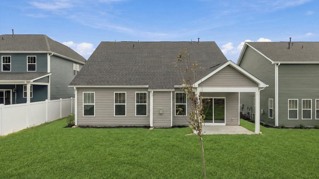 Vibrant rear outdoor space featuring a covered porch and exceptional craftsmanship at Fox Hollow