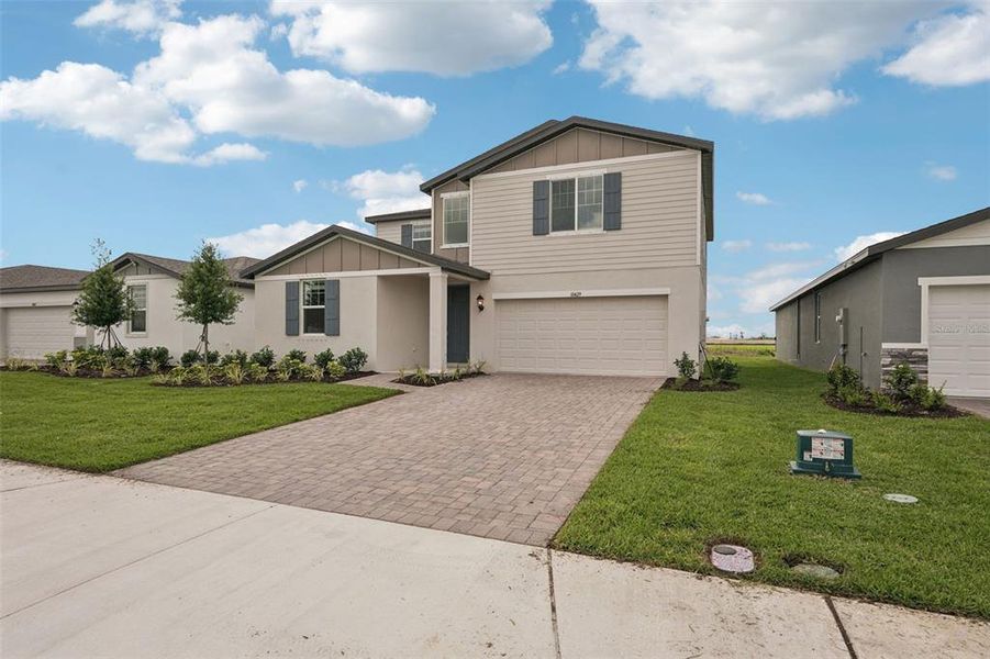 Front exterior of a new home in Oakfield Trails - Classic Series, Parrish, FL, highlighting curb appeal (Image 21). Front exterior of a new home in Oakfield Trails - Classic Series, Parrish, FL, highlighting curb appeal (Image 21).