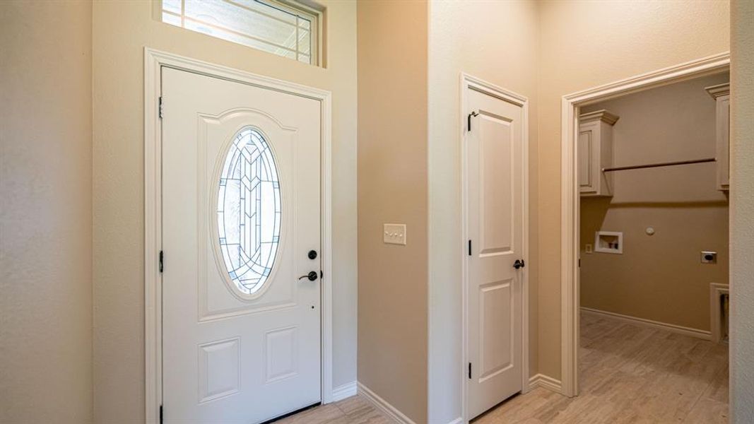 Front entrance with coat closet and access to laundry room Front entrance with coat closet and access to laundry room