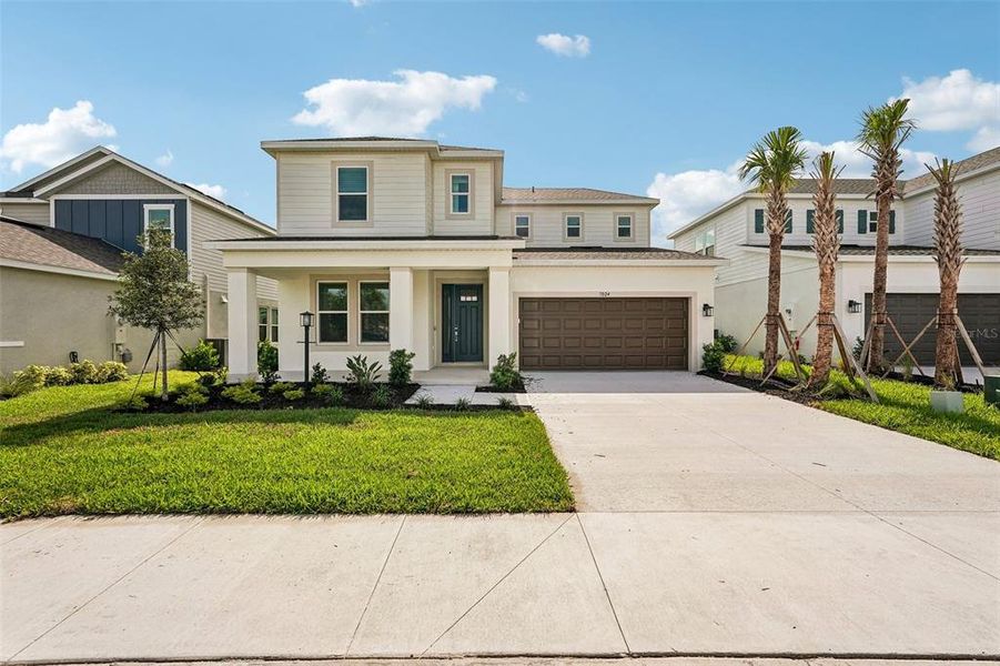 Front exterior of a new home in Tiburon, Nokomis, FL, highlighting curb appeal (Image 25).