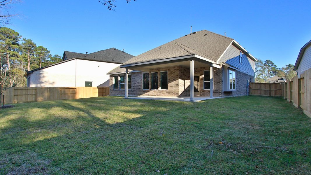 Exterior details and patio area of a home in The Woodlands Hills, Willis (Image 22).
