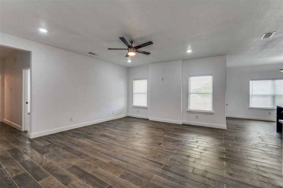 Spare room with ceiling fan, dark wood-type flooring, healthy amount of natural light, and recessed lighting Spare room with ceiling fan, dark wood-type flooring, healthy amount of natural light, and recessed lighting