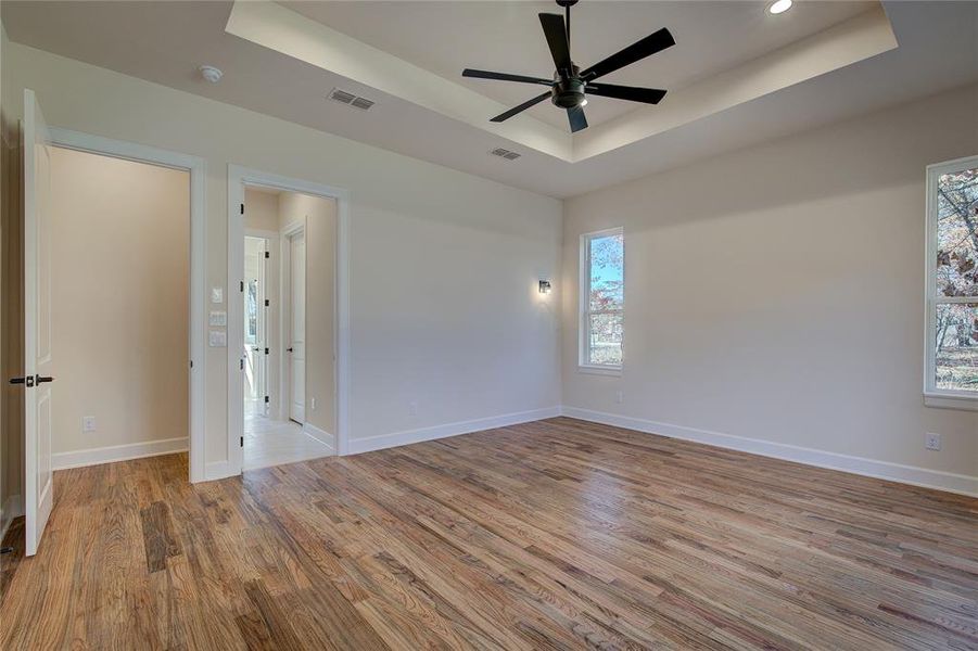Primary bedroom has sconce lights on three walls for reading nooks or bedside lamps.