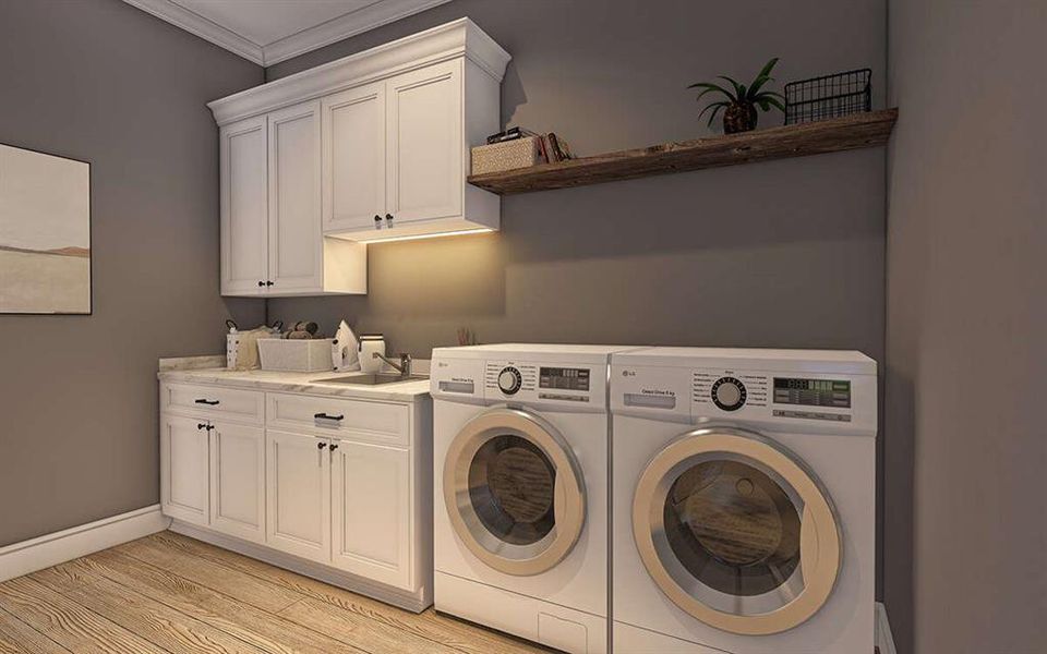 Laundry room with washing machine and clothes dryer, light wood-style flooring, ornamental molding, and cabinet space Laundry room with washing machine and clothes dryer, light wood-style flooring, ornamental molding, and cabinet space