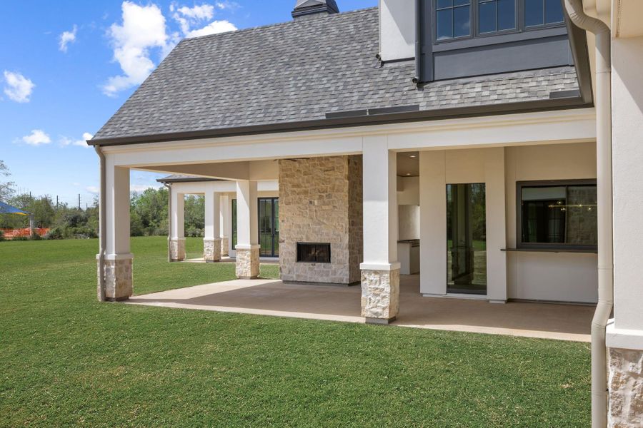 View of rear loggia with fireplace and sitting area. That is the serving vindow that opens awning style from the bar in the game room. View of rear loggia with fireplace and sitting area. That is the serving vindow that opens awning style from the bar in the game room.