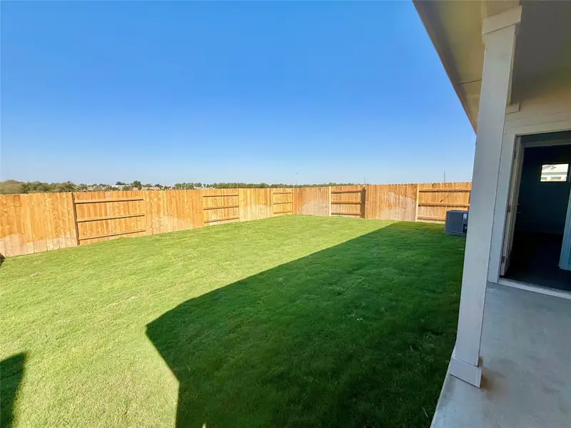 Fenced backyard with a patio area Fenced backyard with a patio area
