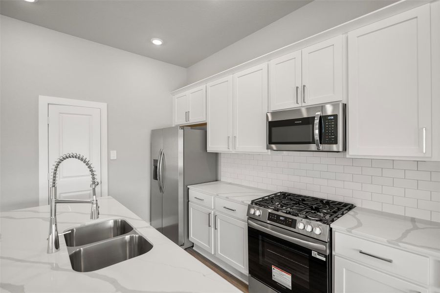 Stunning modern kitchen with sleek cabinetry, quartz or granite countertops, and stainless steel appliances. Stunning modern kitchen with sleek cabinetry, quartz or granite countertops, and stainless steel appliances.