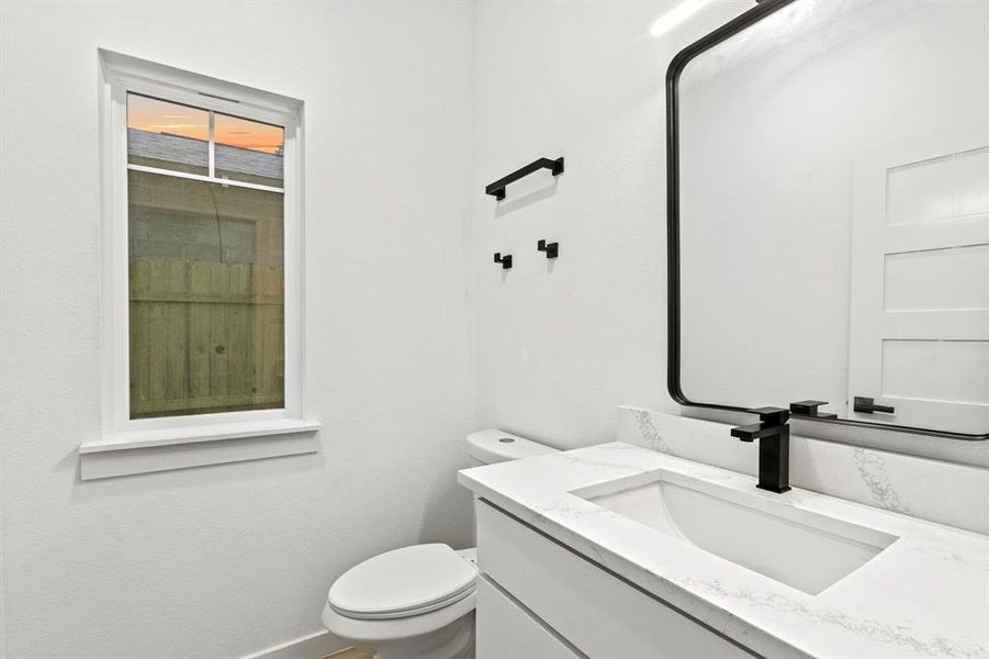 Bathroom with vanity, toilet, and baseboards Bathroom with vanity, toilet, and baseboards