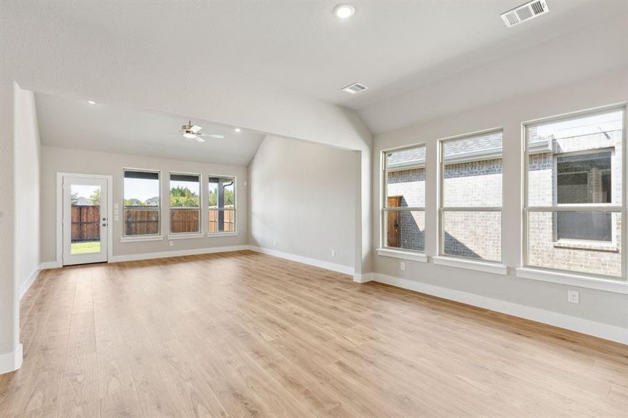 Unfurnished room with light wood-type flooring, recessed lighting, lofted ceiling, and ceiling fan