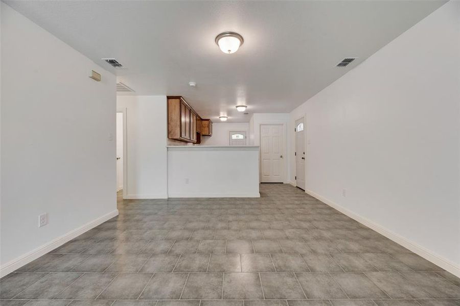 Unfurnished living room with light tile patterned flooring