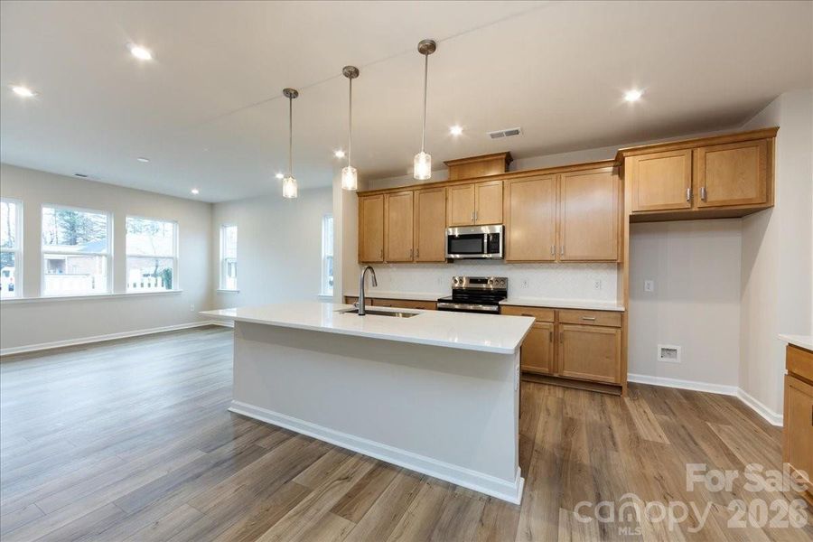 Chef Inspired Kitchen with Warm Brown Cabinets