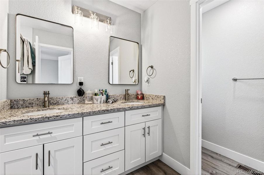 Double sink vanity in primary bedroom. Double sink vanity in primary bedroom.