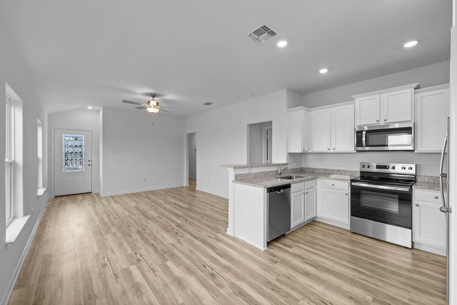 The kitchen of this plan comes completely chef ready. From the plentiful cabinet space and sprawling granite countertops, to the stainless steel Whirlpool® appliances, this room is sure to make a lasting impression. Additionally, you will love how roomy and open this space is!