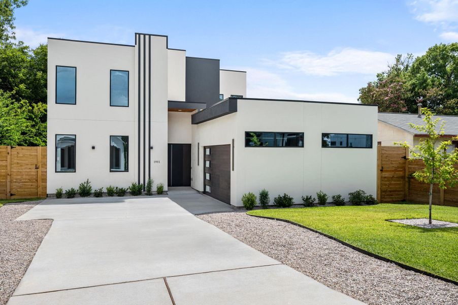 A striking modern facade with clean lines and contrasting dark accents offers captivating curb appeal. A striking modern facade with clean lines and contrasting dark accents offers captivating curb appeal.