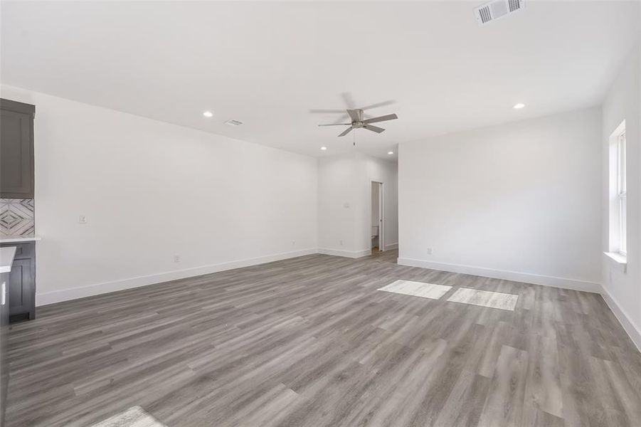 Unfurnished living room featuring light wood finished floors, recessed lighting, and a ceiling fan