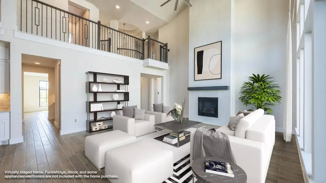 Living area with wood finish floors, a towering ceiling, a fireplace, and recessed lighting Living area with wood finish floors, a towering ceiling, a fireplace, and recessed lighting