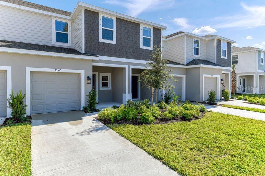 Front exterior of a new home in Vinterra Townhomes, Nokomis, FL, highlighting curb appeal (Image 1). Front exterior of a new home in Vinterra Townhomes, Nokomis, FL, highlighting curb appeal (Image 1).
