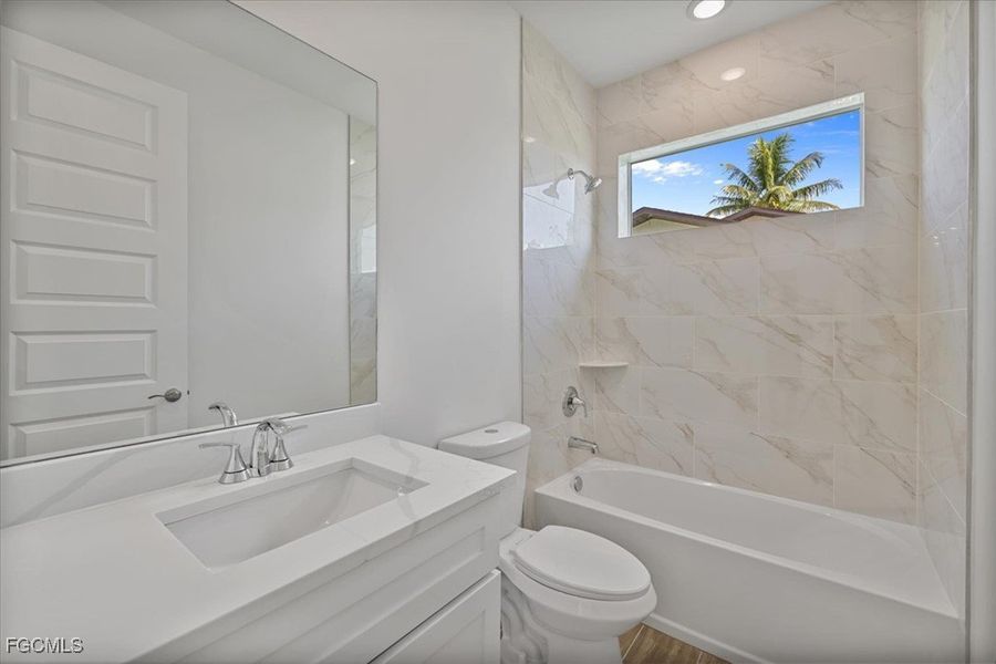 Full bath featuring tub / shower combination and vanity