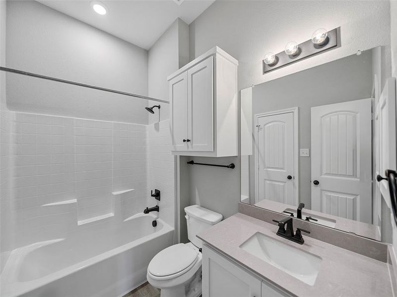 Full bath featuring shower / tub combination, toilet, and vanity