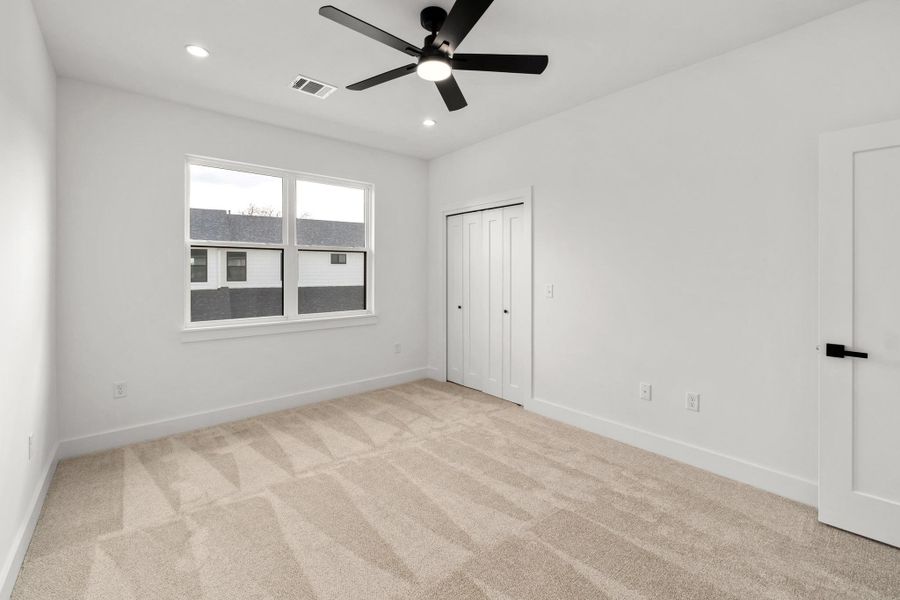 Unfurnished bedroom featuring light colored carpet, ceiling fan, recessed lighting, and a closet