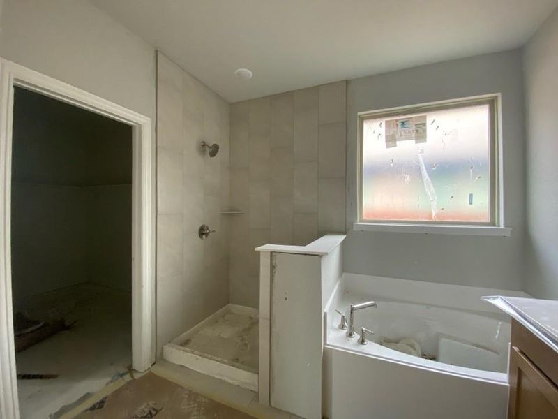 Step-in shower with tiled walls and a built-in shelf
