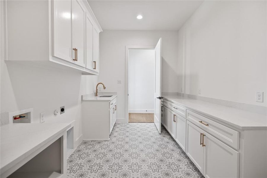 Washroom with cabinet space, hookup for a washing machine, electric dryer hookup, and recessed lighting Washroom with cabinet space, hookup for a washing machine, electric dryer hookup, and recessed lighting