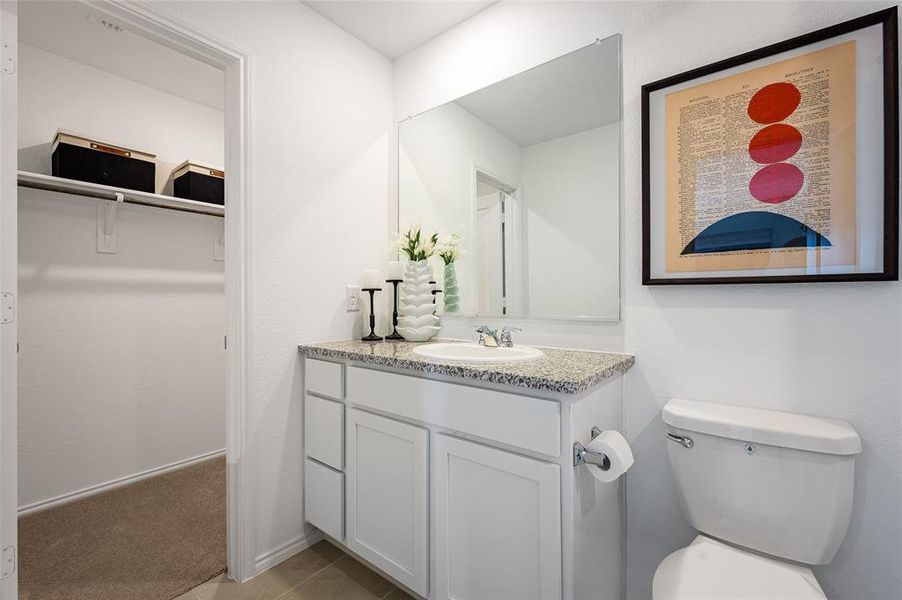 Bathroom with vanity, tile patterned floors, and toilet