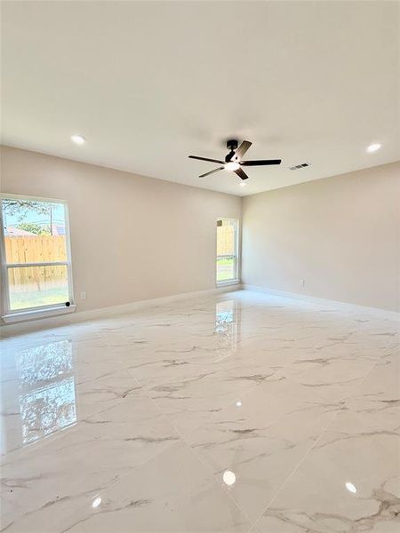 Unfurnished room featuring marble finish flooring, ceiling fan, baseboards, and recessed lighting
