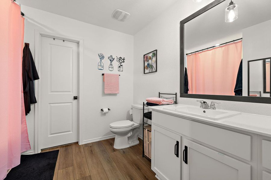 Primary bathroom features updated light fixtures and shower head to add a modern touch. Primary bathroom features updated light fixtures and shower head to add a modern touch.