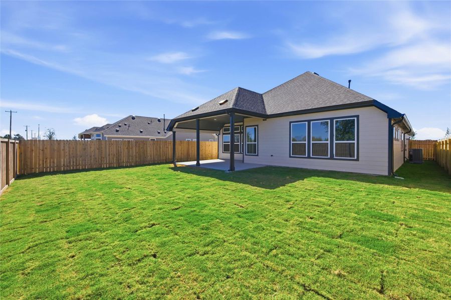 Rear view of property featuring a shingled roof, a patio, and a fenced backyard Rear view of property featuring a shingled roof, a patio, and a fenced backyard