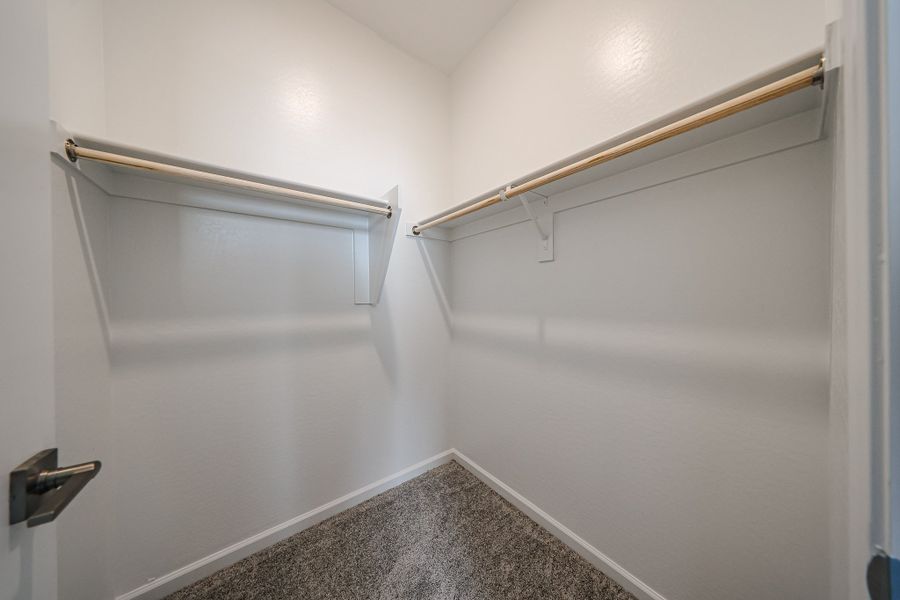 A white wall with a metal bar.