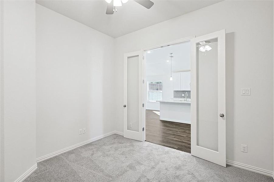 Unfurnished bedroom featuring carpet flooring, french doors, ceiling fan, and sink