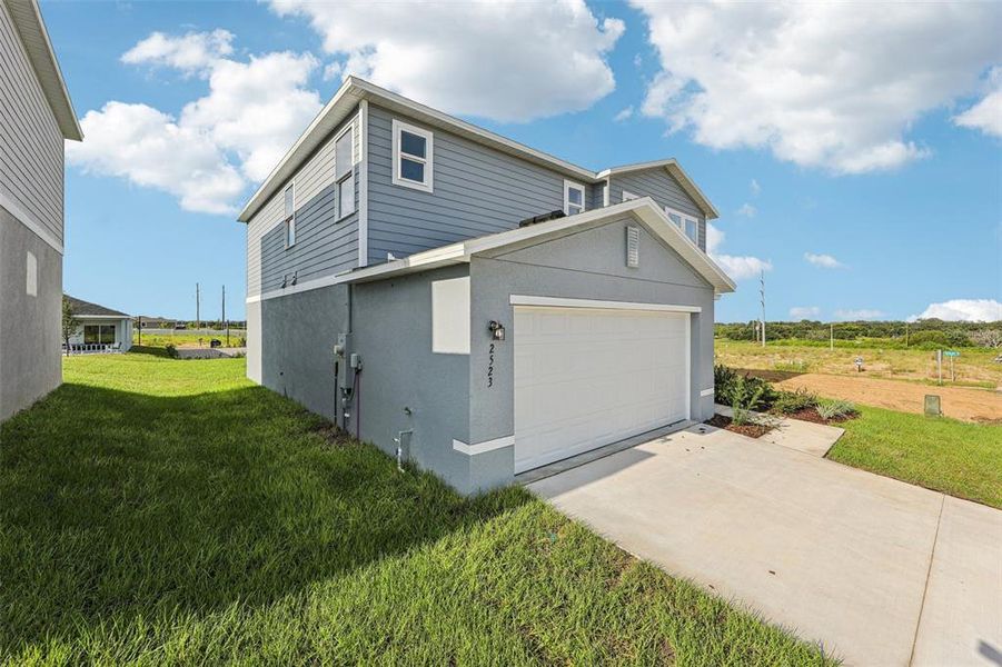 Front exterior of a new home in Bradbury Creek, Haines City, FL, highlighting curb appeal (Image 7).