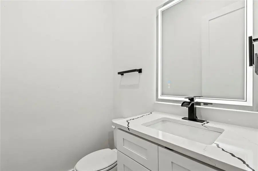 Bathroom featuring vanity and toilet