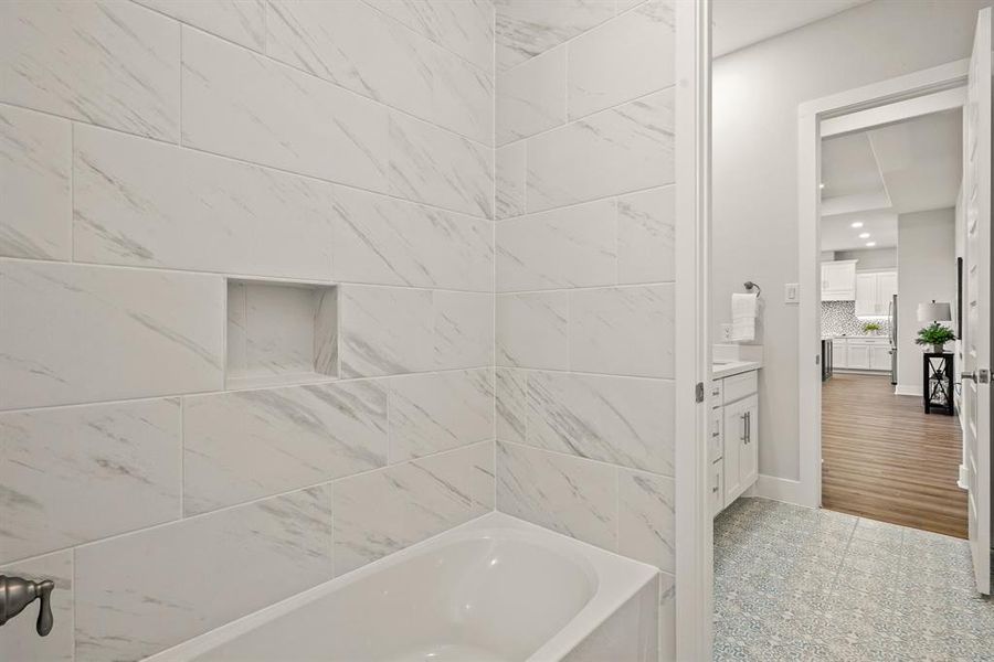 Unique to this Bathroom, one person can access the tiled shower/tub combo and toilet, while another person can be getting ready at the vanity, thanks to the door positioned between the two spaces. Once again, form meets function.