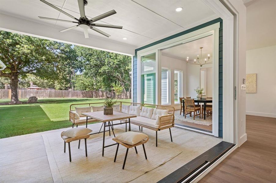 Fenced backyard featuring outdoor dining area, ceiling fan, and a patio area